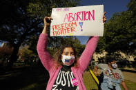 An abortion rights supporter holds one of many signs that was displayed at a reproductive rights rally at Smith Park in Jackson, Miss., Wednesday, Dec. 1, 2021. The U.S. Supreme Court on Wednesday heard a Mississippi case that directly challenges the constitutional right to an abortion established nearly 50 years ago. (AP Photo/Rogelio V. Solis)