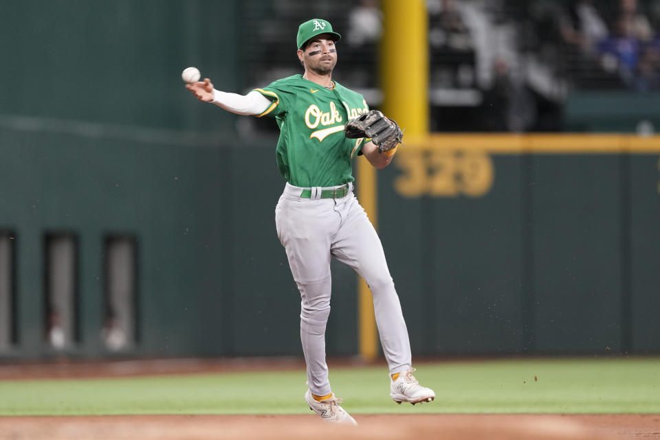 Oakland Athletics shortstop Tyler Wade throws a groundout to first base by Texas Rangers' Josh Jung during the first inning of a baseball game, Sunday, April 23, 2023, in Arlington, Texas. (AP Photo/Jim Cowsert)