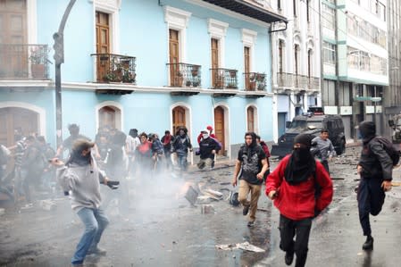 Demonstrators clash with riot police during protests after Ecuadorian President Lenin Moreno's government ended four-decade-old fuel subsidies, in Quito