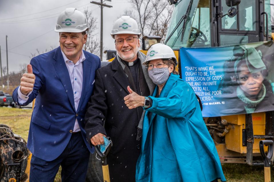 Ford CEO Jim Farley poses in December for a picture with the Rev. Tim McCabe and Julia Burke Foundation Board Member Robbie Murphy after the groundbreaking ceremony for Pope Francis Center's New Bridge Housing Campus to end chronic homelessness in Detroit. The campus has received $30 million to build the development with an extra $6 million from the Julia Burke Foundation for extra construction costs.