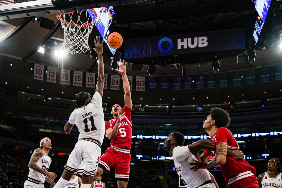 Indiana forward Malik Reneau (5) shoots over Louisville center Dennis Evans (11) in an NCAA college basketball game in the Empire Classic tournament in New York, Monday, Nov. 20, 2023. (AP Photo/Peter K. Afriyie)
