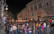 Crowds gather outside the Perugia court expectantly.