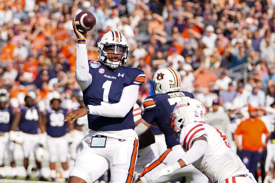 Dec 28, 2021; Birmingham, Alabama, USA; Auburn Tigers quarterback TJ Finley (1) passes against the Houston Cougars during the second half of the 2021 Birmingham Bowl at Protective Stadium.