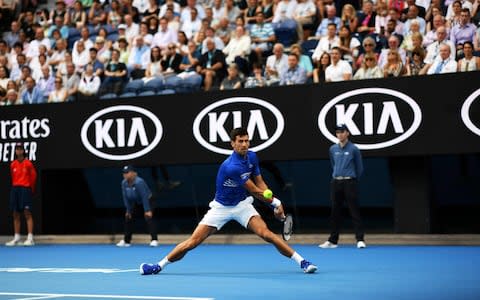 Serbia's Novak Djokovic hits a return against France's Lucas Pouille during their men's singles semi-final match on day 12 of the Australian Open tennis tournament in Melbourne on January 25, 2019. - Credit: AFP