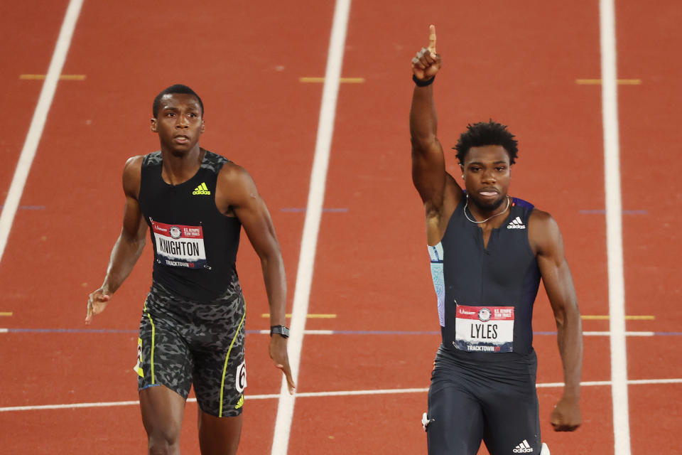 Noah Lyles (pictured right) raising his hand after winning the Men's 200 Meter Final ahead of Erriyon Knighton (pictured left).