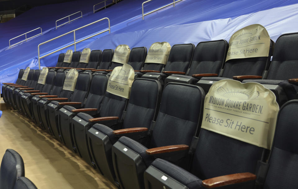 Seats are earmarked for fans at future games prior to the NHL hockey game between the New York Rangers and the Boston Bruins at Madison Square Garden Wednesday, Feb. 10, 2021, in New York. New York State announced today that arenas can re-open on Feb. 23 at 10% occupancy. (Bruce Bennett/Pool Photo via AP)