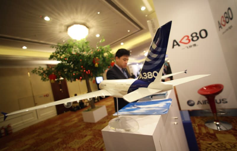 A delegate gets information from an Airbus booth during the 68th International Air Transport Association (IATA) annual general meeting in Beijing June 11, 2012. Airbus sales chief John Leahy said he was "very relaxed" about the slow-selling A350-1000 and hinted a three-year order drought for the $320 million passenger jet could come to an end soon. REUTERS/Jason Lee