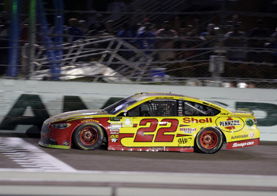 Joey Logano (22) approaches the finish line to win a NASCAR Cup Series Championship auto race at the Homestead-Miami Speedway, Sunday, Nov. 18, 2018, in Homestead, Fla. (AP Photo/Terry Renna)