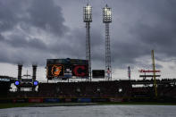A tarp covers the field as it rains during a rain delay before a baseball game between the Baltimore Orioles and the Cincinnati Reds, Friday, May 3, 2024, in Cincinnati. (AP Photo/Carolyn Kaster)