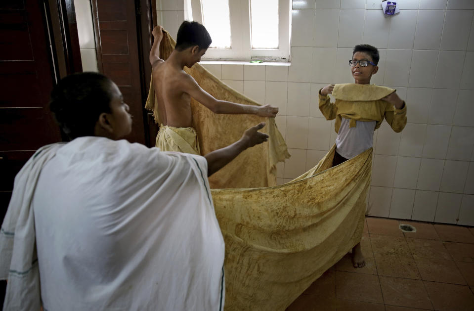 Schoolchildren dress up as statues depicting Indian freedom leader Mahatma Gandhi's Dandi March, on the eve of Gandhi's 150th birth anniversary in New Delhi, India, Tuesday, Oct. 1, 2019. Dandi March is the name given to the Salt Satyagraha (Salt March) where Gandhi and other freedom fighters marched 241 miles to the sea to make their own salt on April 6, 1930 as an act of civil disobedience against the British colonial rule. (AP Photo/Altaf Qadri)