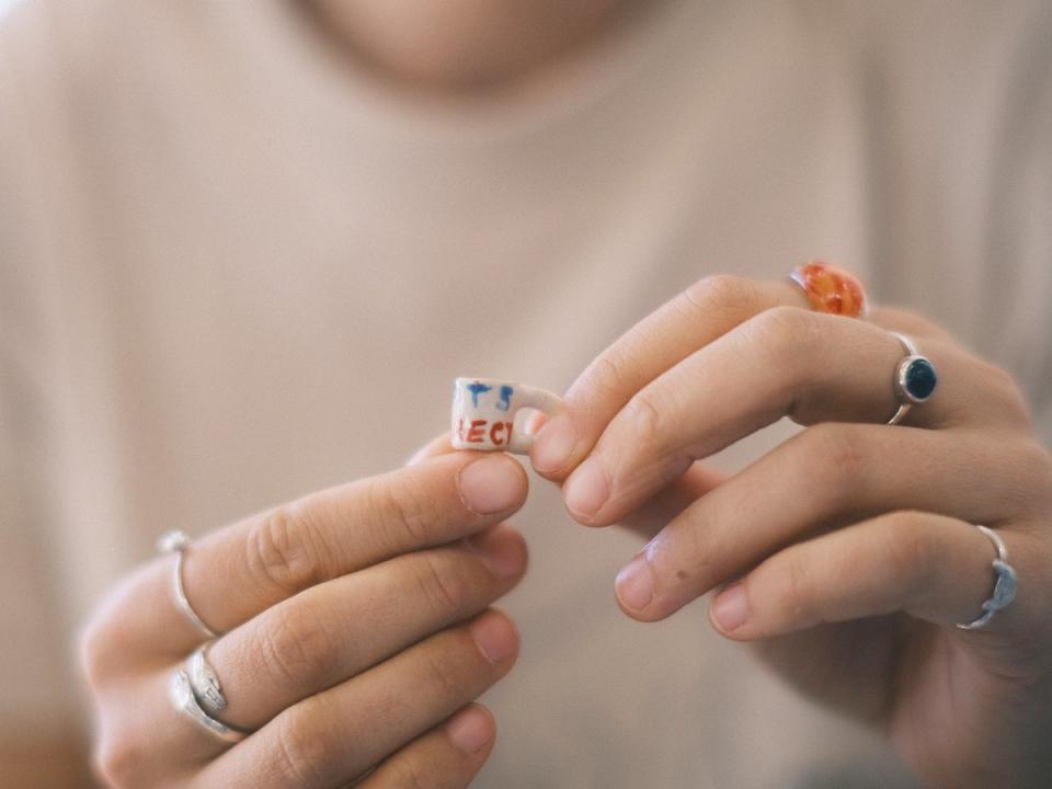 Artist Veronika McQuade with one of her tiny ‘Sports Indirect’ miniatures (Veronika McQuade)