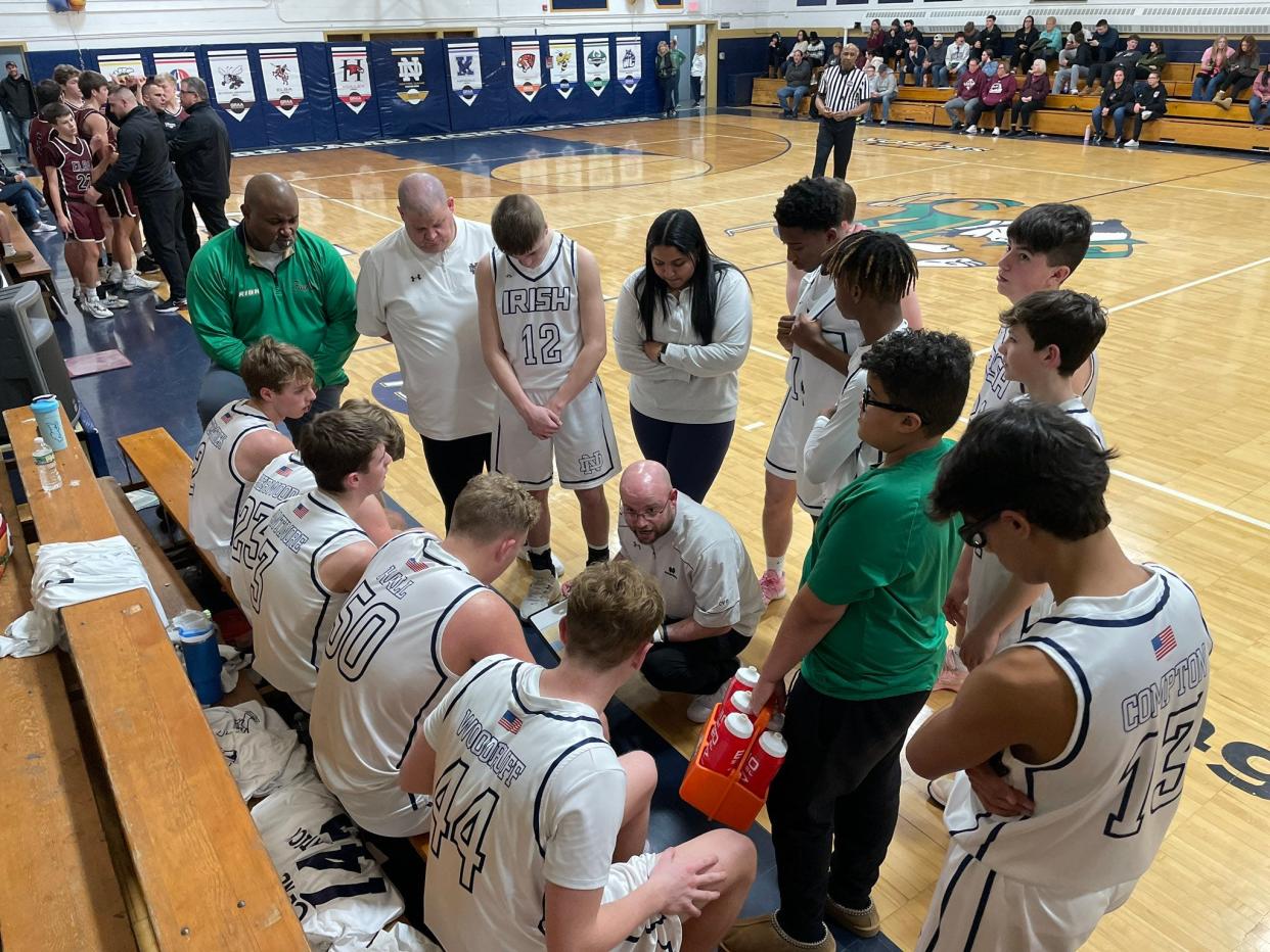 Batavia Notre Dame coach Mikey Rapone huddles with his Fighting Irish during a timeout of a 66-49 Genesee Region win over visiting Elba on Tuesday, Feb. 6, 2024. Notre Dame is 13-4 and ranked No. 24 on the latest Class C state poll.