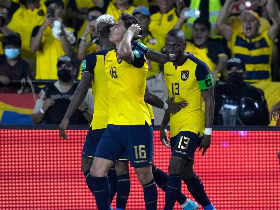 A group of Ecuador players gather and celebrate during a match.