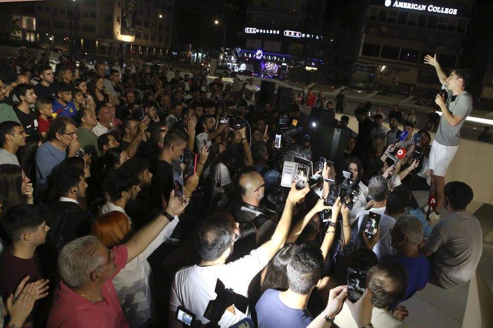 Fidias Panayiotou, right, speaks to his supporters after elected in the European Elections in capital Nicosia, Cyprus, Sunday, June 9, 2024. Panayiotou, a popular YouTuber and TikToker who's humorous and occasionally obnoxious posts have earned him tens of thousands of followers has stunned Cyprus' political world by appearing to wrest one of six seats allotted to the island nation in the European Parliament from traditional political powerhouses. (AP Photo/Philippos Christou)