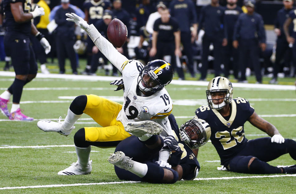 Pittsburgh Steelers wide receiver JuJu Smith-Schuster (19) fumbles the ball as New Orleans Saints defensive tackle Sheldon Rankins tackles him, causing a turnover in the final minute of the second half of an NFL football game in New Orleans, Sunday, Dec. 23, 2018. The Saints won 31-28, clinching the top seed for the NFC and home field advantage for the playoffs. (AP Photo/Butch Dill)