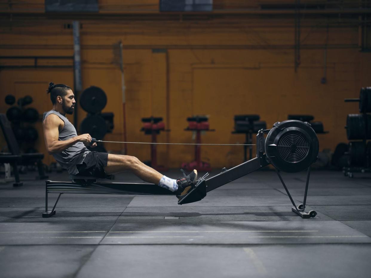 young adult man cross training in a gym