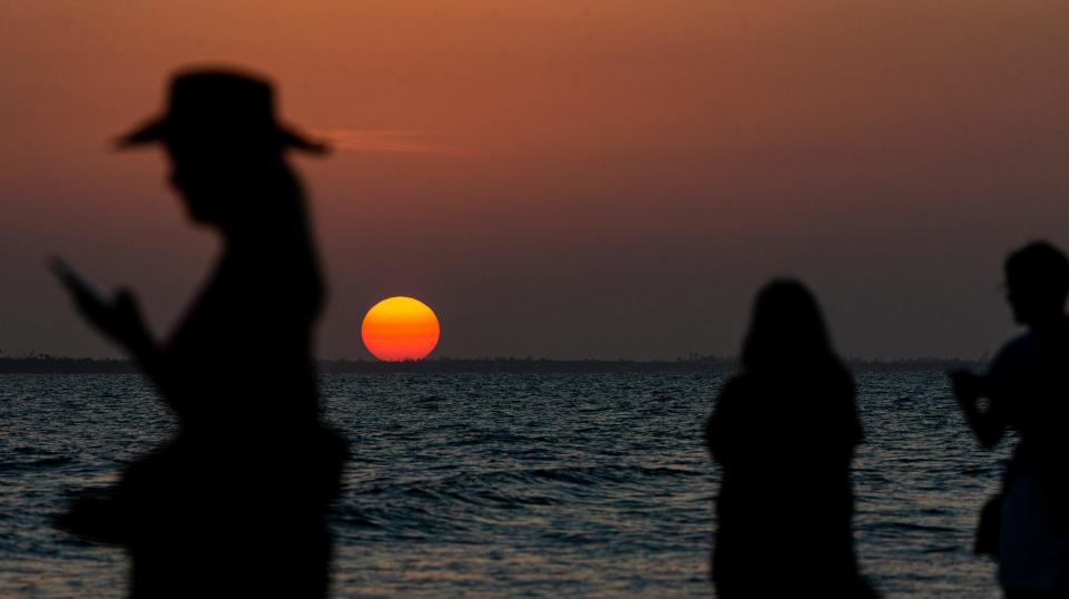 The sun sets on Fort Myers Beach on Monday, March 27, 2023.