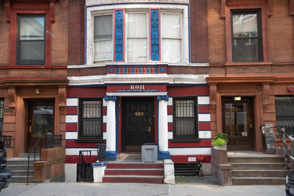 The exterior of a frat house in a city