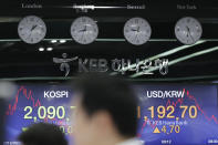 A currency trader watches his computer monitors near screens showing the Korea Composite Stock Price Index (KOSPI), left, and the foreign exchange rate between U.S. dollar and South Korean won at the foreign exchange dealing room in Seoul, South Korea, Monday, Sept. 23, 2019. Stocks got a downbeat start to the week as investors kept a wary eye on tensions with Iran and on signals from China and the U.S. on prospects for a resolution of their tariffs war. (AP Photo/Lee Jin-man)