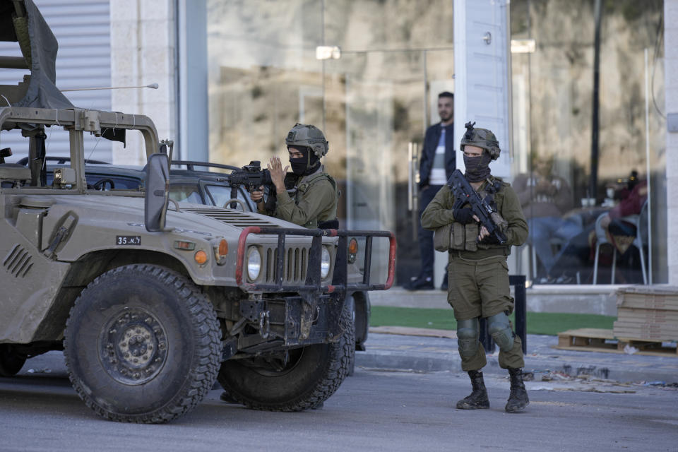 Israeli soldiers operate in village of Sarra near the Palestinians West Bank city of Nablus, Sunday, March 12, 2023. Israeli forces fatally shot three Palestinian gunmen who opened fire on troops in the occupied West Bank. It was the latest bloodshed in a year-long wave of violence in the region. (AP Photo/Majdi Mohammed)