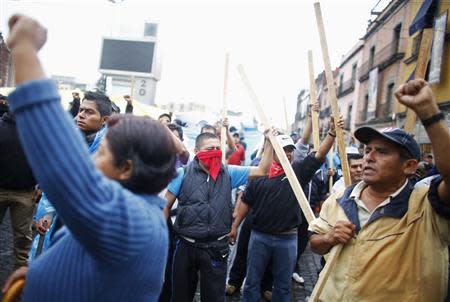 Protesters yell slogans while standing on the Zocalo in Mexico City September 13, 2013. (REUTERS/Tomas Bravo)