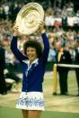 <p>Billie Jean King holds the trophy aloft after winning the Women's Singles event in 1975.</p>