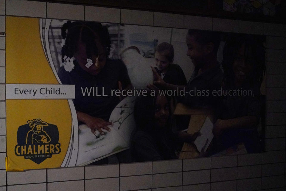 A sign is displayed in the hallway at Chalmers Elementary school in Chicago, Wednesday, July 13, 2022. America's big cities are seeing their schools shrink, with more and more of their schools serving small numbers of students. Those small schools are expensive to run and often still can't offer everything students need (now more than ever), like nurses and music programs. Chicago and New York City are among the places that have spent COVID relief money to keep schools open, prioritizing stability for students and families. But that has come with tradeoffs. And as federal funds dry up and enrollment falls, it may not be enough to prevent districts from closing schools. (AP Photo/Nam Y. Huh)