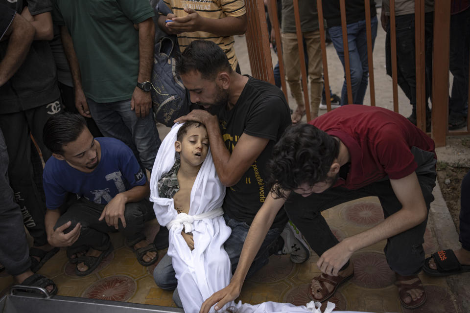 Palestinians mourn their relatives killed in the Israeli bombardment of the Gaza Strip, in a morgue in Khan Younis, Sunday, Oct. 29, 2023. ( AP Photo/Fatima Shbair)