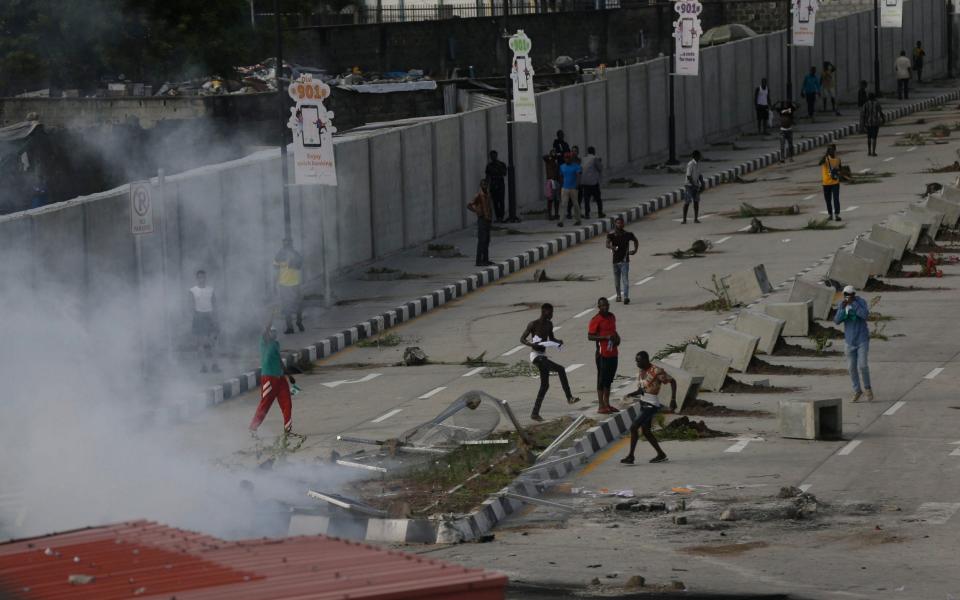 Police used tear gas to disperse protesters in Lagos and insisted they did not use live rounds - AP