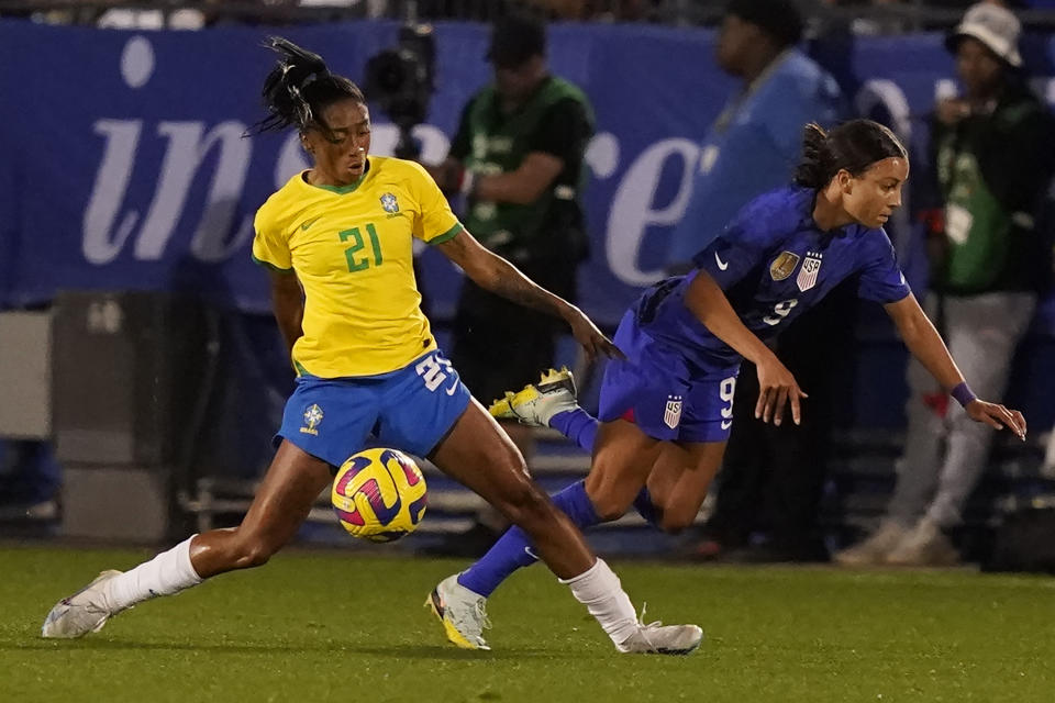 United States forward Mallory Swanson (9) is fouled by Brazil midfielder Kerolin (21) during the second half of a SheBelieves Cup soccer match Wednesday, Feb. 22, 2023, in Frisco, Texas. The United States won 2-0. (AP Photo/LM Otero)