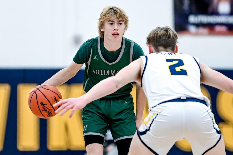 Williamston's Max McCune, left, moves the ball as Haslett's Brayden Stellard defends during the game on Friday, Dec. 16, 2022, at Haslett High School.