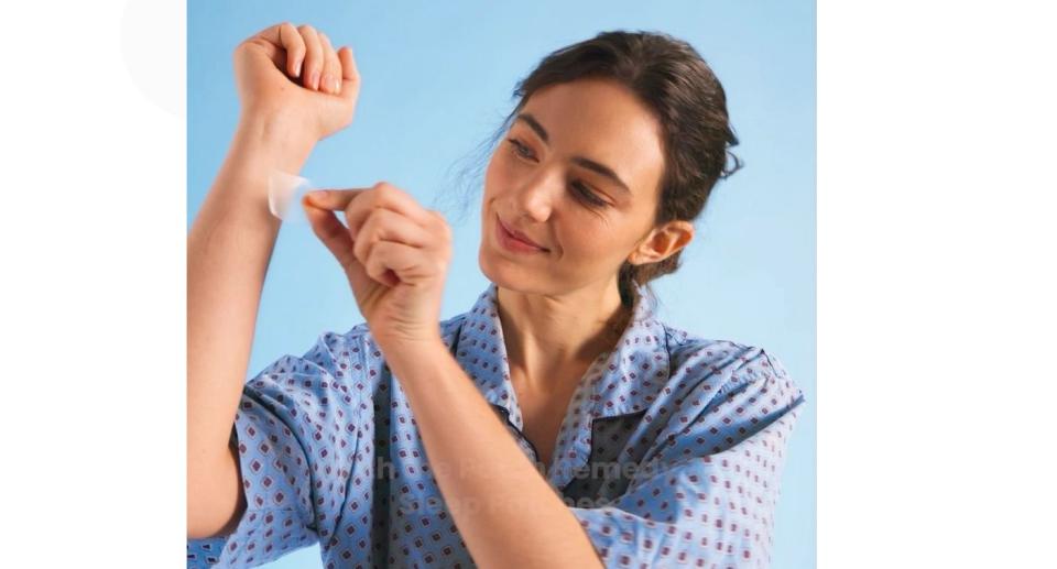 Woman using SLEEP patch on her wrist