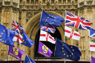 Various flags flutter in the wind outside the houses of Parliament in London, Monday, Oct. 21, 2019. There are just 10 days until the U.K. is due to leave the European bloc on Oct. 31.(AP Photo/Alberto Pezzali)