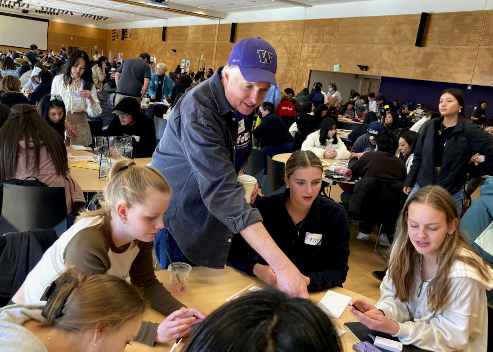 Ballard High School social studies teacher Shawn Lee talks to his students at MisinfoDay, an event hosted by the University of Washington to help high school students identify and avoid misinformation, Tuesday, March 14, 2023, in Seattle. Educators around the country are pushing for greater digital media literacy education. (AP Photo/Manuel Valdes)