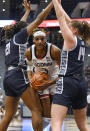 UConn's Aaliyah Edwards (3) is stopped by the defense of Georgetown's Ariel Jenkins (21) and Kristina Moore (14) in the first half of an NCAA college basketball game, Sunday, Jan. 15, 2023, in Hartford, Conn. (AP Photo/Jessica Hill)