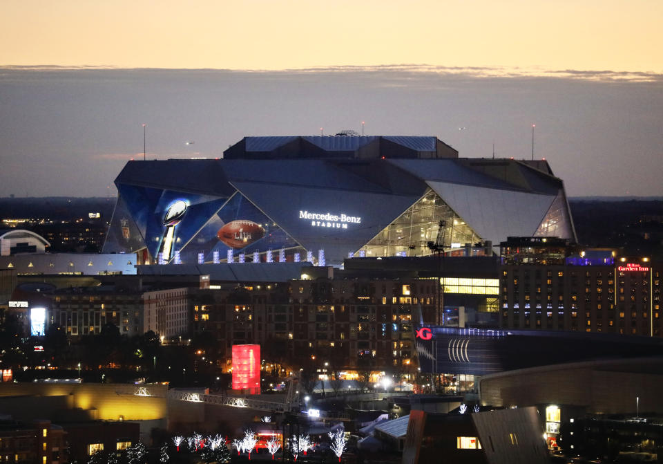 The sun sets behind Mercedes-Benz Stadium ahead of Sunday's NFL Super Bowl 53 football game between the Los Angeles Rams and New England Patriots in Atlanta, Friday, Feb. 1, 2019. (AP Photo/David Goldman)