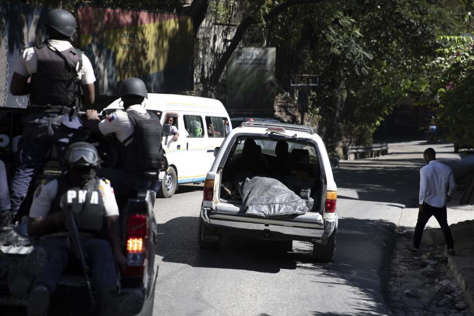 FILE - Police carry away the bodies of slain journalists in Port-au-Prince, Haiti, Friday, Jan. 7, 2022. According to a report released Tuesday, Jan. 24, 2023, by the New York-based Committee to Protect Journalists, killings of journalists around the world jumped by 50% in 2022 compared to the previous year, driven largely by murders of reporters in the three deadliest countries: Ukraine, Mexico and Haiti. (AP Photo/Odelyn Joseph, File)