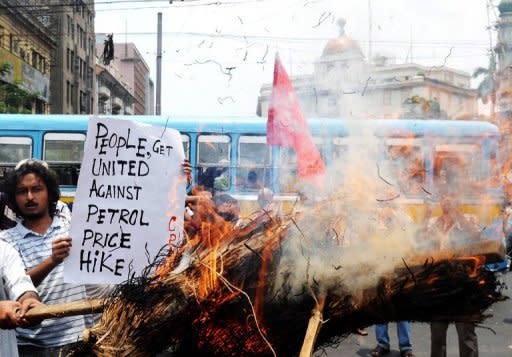 Activists of a leftist organisation burn an effigy of the prime minster Manmohan Singh in Kolkata on Thursday in protest against the recent petrol price hike