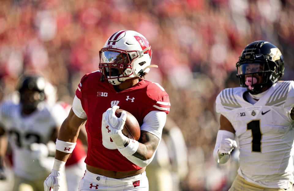 Wisconsin running back Braelon Allen runs against Purdue defensive back Reese Taylor (1) for a first down during the first half of an NCAA college football game Saturday, Oct. 22, 2022, in Madison, Wis. (AP Photo/Andy Manis)