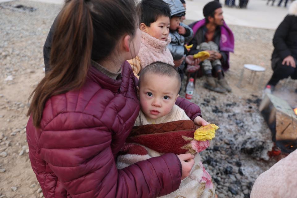 Residents gather outdoors the morning after an earthquake in Dahejia, Jishishan County, in northwest China's Gansu province (AFP via Getty Images)