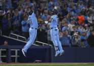 Toronto Blue Jays designated hitter Justin Turner, right, celebrates after his solo home run with third base coach Carlos Febles (51) while playing against the Kansas City Royals during third-inning baseball game action in Toronto, Monday, April 29, 2024. (Nathan Denette/The Canadian Press via AP)