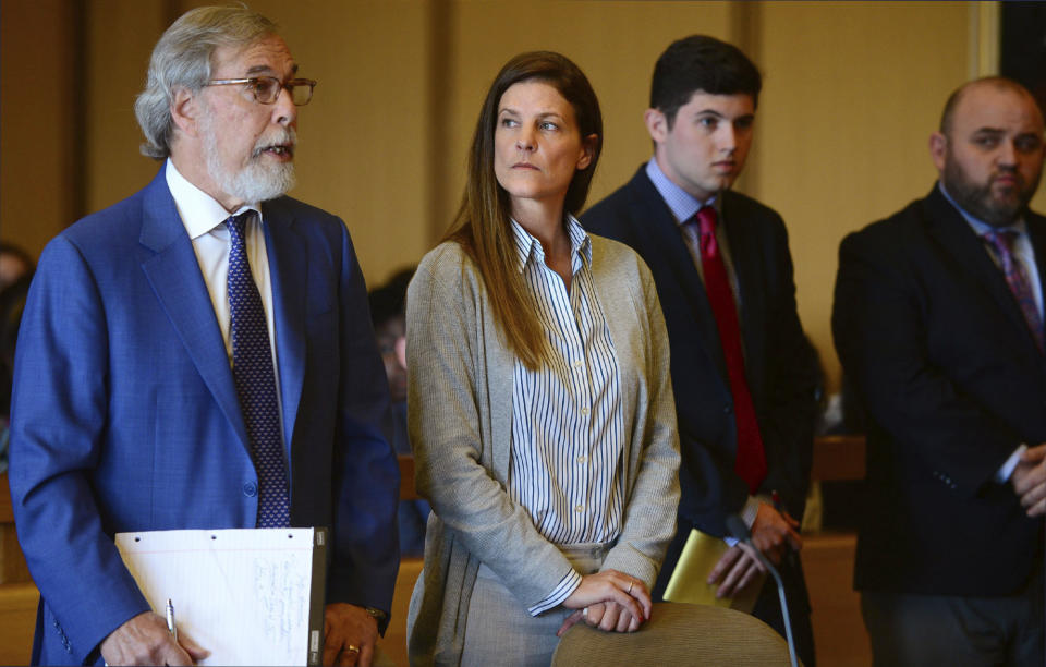 Michelle Troconis, center, listens as a member of her legal team Andrew Bowman, left, addresses the court during a hearing at Stamford Superior Court, Tuesday, June 11, 2019 in Stamford, Conn. Fotis Dulos, and his girlfriend, Michelle Troconis, have been charged with evidence tampering and hindering prosecution in the disappearance of his wife Jennifer Dulos. The mother of five has has been missing since May 24. (Erik Trautmann/Hearst Connecticut Media via AP, Pool)