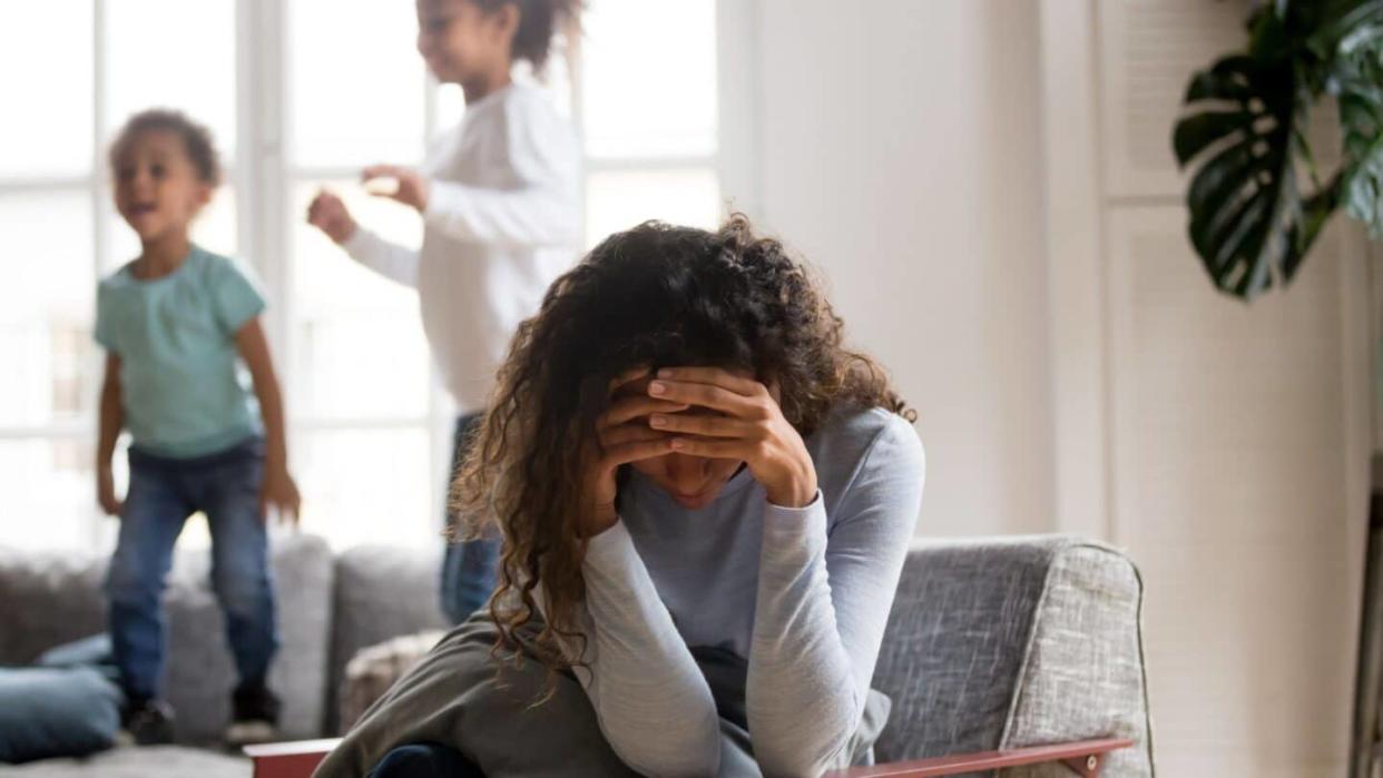 stressed mom with head in hands - gentle parenting