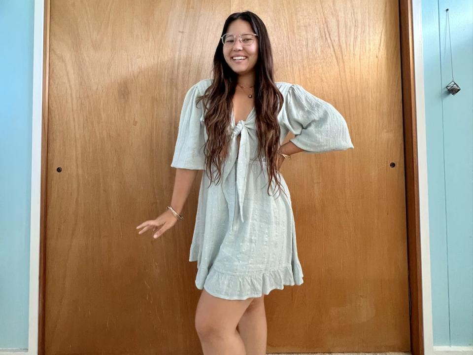 Ashley wearing a light-blue babydoll dress