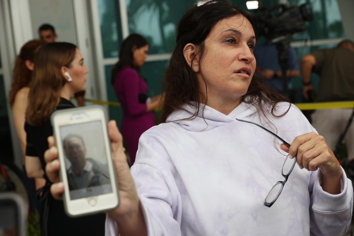 Soriya Cohen shows a picture of her husband, Brad Cohen, who she said is missing after the partial collapse of the 12-story condo tower that he was in on June 24, 2021 in Surfside, Florida. (Getty Images)