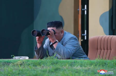 North Korean leader Kim Jong Un watches the test-fire of two short-range ballistic missiles