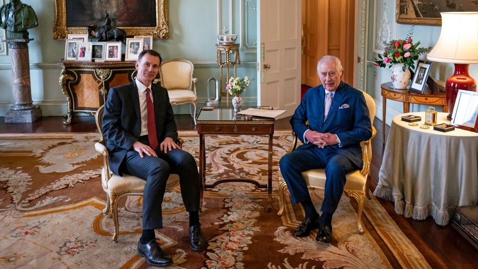 King Charles III and Britain's Chancellor of the Exchequer Jeremy Hunt, pose for a photograph during their meeting in the private audience room at Buckingham Palace