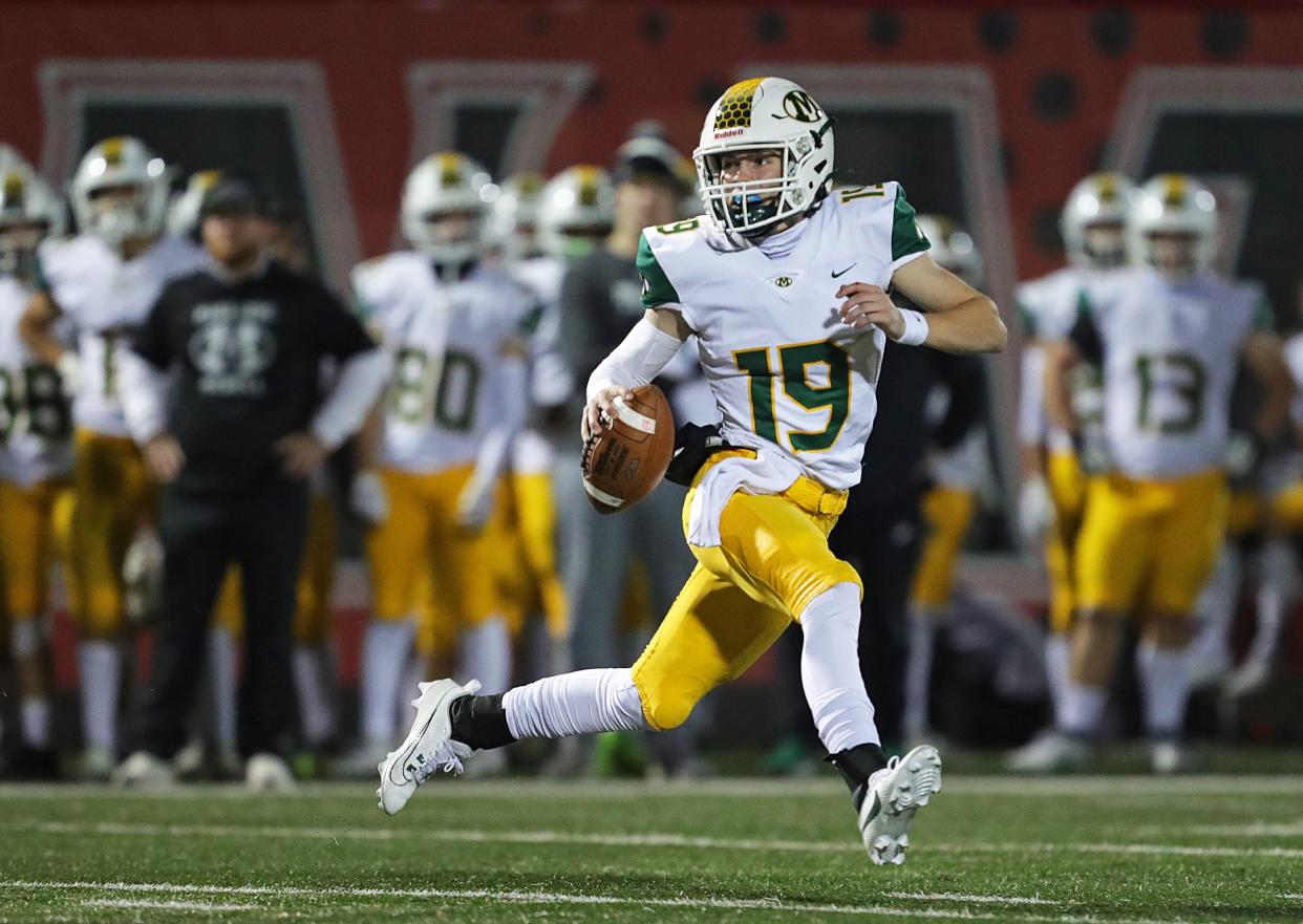 Medina quarterback Danny Stoddard runs during the first half of a Division I regional quarterfinal football game, Friday, Nov. 3, 2023, in Wadsworth, Ohio.