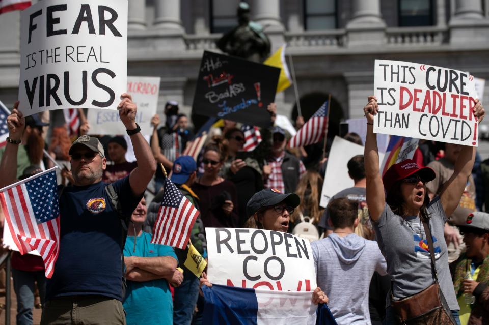 Demonstrators gather in front of the Colorado State Capitol building to protest coronavirus stay-at-home orders during a "ReOpen Colorado" rally in Denver on April 19, 2020. (Photo: JASON CONNOLLY via Getty Images)