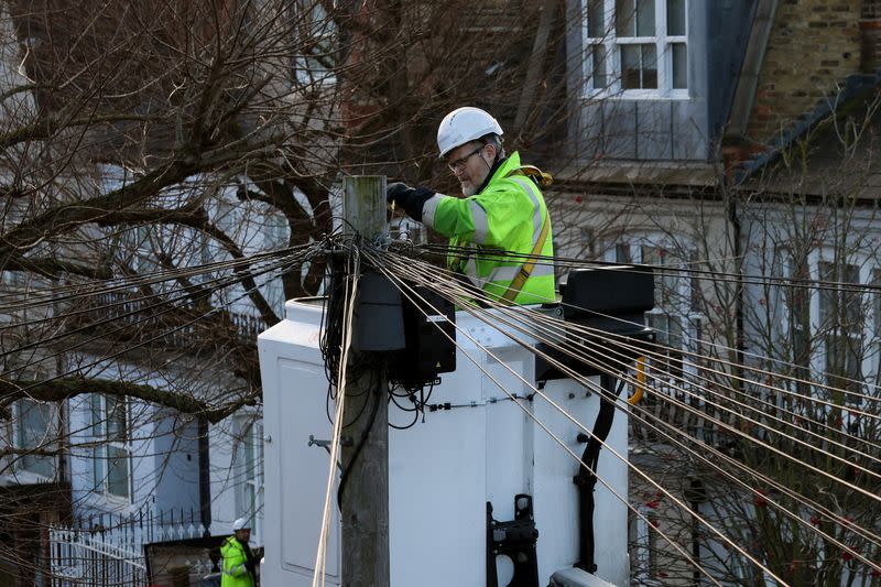 An Openreach engineer works on telephone lines in a residential street in London